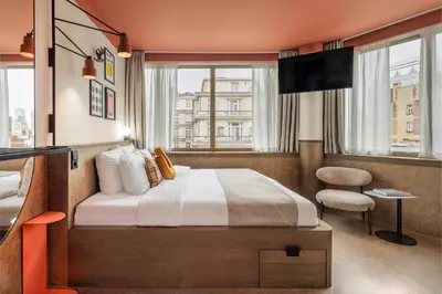 a hotel room with a bed and a television at The Usual Brussels in Brussels