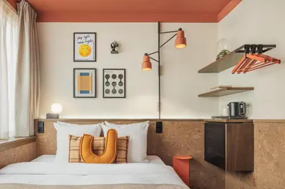 a bedroom with a bed with a wooden headboard at The Usual Brussels in Brussels