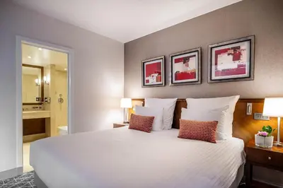 a bedroom with a large white bed with two pillows at Warwick Grand-Place Brussels in Brussels