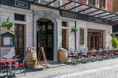 a row of tables and chairs outside of a restaurant at Warwick Grand-Place Brussels in Brussels