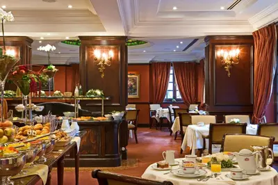 a dining room with tables with food on them at Warwick Grand-Place Brussels in Brussels
