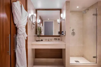 a bathroom with a sink and a shower at Warwick Grand-Place Brussels in Brussels