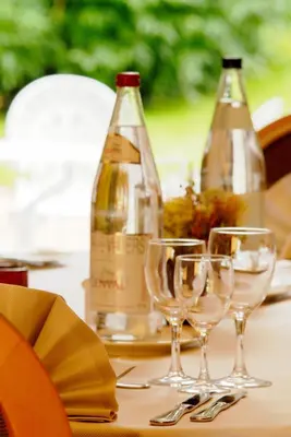 a table with wine bottles and wine glasses on it at Martin's Manoir in Genval
