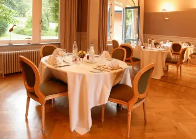 a dining room with white tables and chairs at Martin's Manoir in Genval