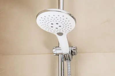 a shower with a shower head in a bathroom at NH Mechelen in Mechelen