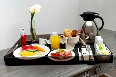 a tray of breakfast food on a table at NH Mechelen in Mechelen