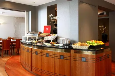 a kitchen with a counter with fruit on it at NH Mechelen in Mechelen