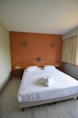 a bedroom with a large white bed with two pillows at Sleep & Go Brussels Expo Hotel in Brussels