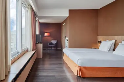 a hotel room with a large bed and a window at Theater Hotel in Antwerp