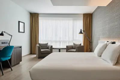 a hotel room with a bed and a desk and chairs at Theater Hotel in Antwerp
