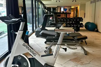 a fitness room with a gym with a treadmill at PREMIER SUITES Antwerp in Antwerp