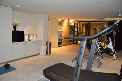 a fitness room with a gym with a treadmill at PREMIER SUITES Antwerp in Antwerp