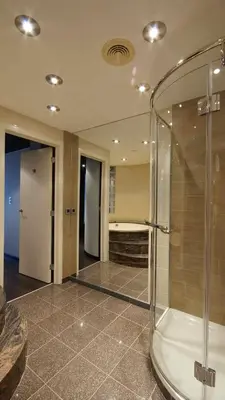 a bathroom with a shower with a glass door at De Keyser Hotel in Antwerp