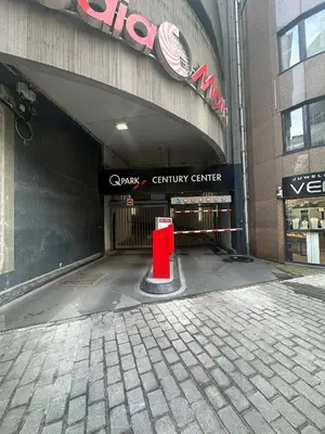 a subway entrance with a red object in front of a building at De Keyser Hotel in Antwerp