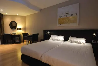 a hotel room with a bed and a desk at De Keyser Hotel in Antwerp