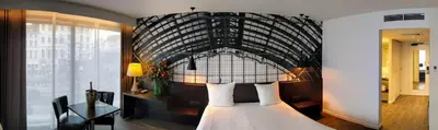 a bedroom with a bed with a head board at De Keyser Hotel in Antwerp