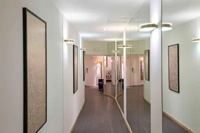 a hallway with paintings on the walls and a hallway with a hallwayngth at Hôtel Argus by happyCulture in Brussels