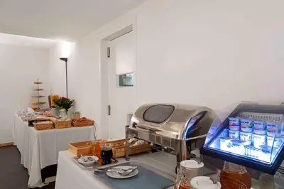 a hospital room with a bed and a table at Hôtel Argus by happyCulture in Brussels