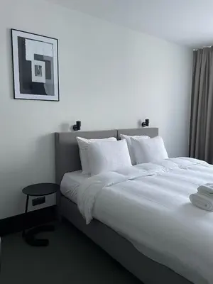 a bedroom with a large bed with white pillows at Hotel National Antwerp in Antwerp