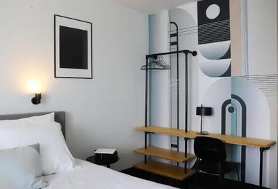 a bedroom with a desk next to a bed at Hotel National Antwerp in Antwerp