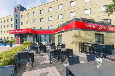 a restaurant with tables and chairs in front of a building at Thon Hotel Brussels Airport in Diegem
