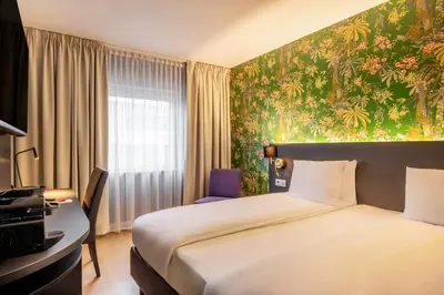 a hotel room with a bed and a desk at Thon Hotel Brussels Airport in Diegem