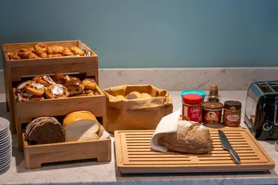 a table with two wooden trays with different types of bread at Thon Hotel Brussels Airport in Diegem