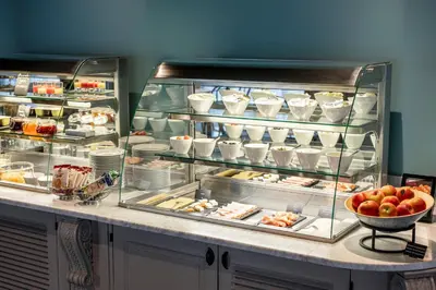 a display case in a restaurant with some food at Thon Hotel Brussels Airport in Diegem