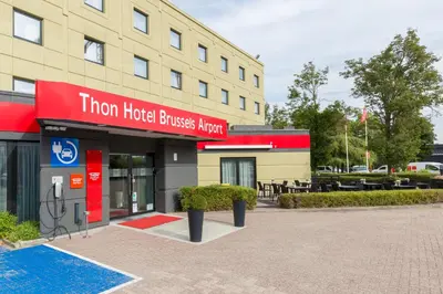 a hotel building with a sign that reads titan hotel business hotel at Thon Hotel Brussels Airport in Diegem