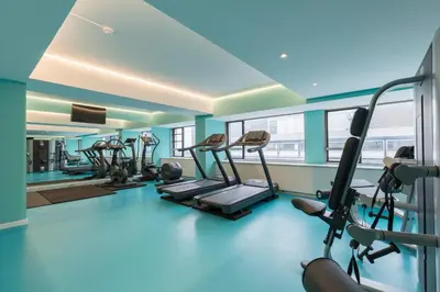 a gym with several treadmills and ellipticals at Thon Hotel Brussels City Centre in Brussels