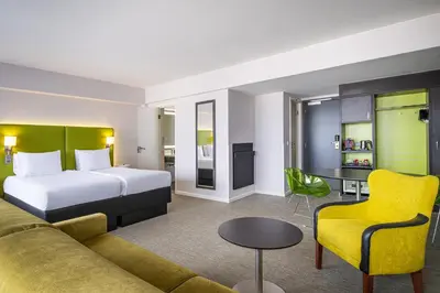 a hotel room with a bed and a couch at Thon Hotel Brussels City Centre in Brussels