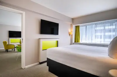 a hotel room with a large bed and a window at Thon Hotel Brussels City Centre in Brussels