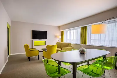a living room with a table and chairs at Thon Hotel Brussels City Centre in Brussels