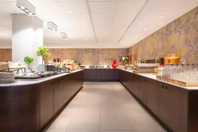 a restaurant with a long counter in a room at Thon Hotel Brussels City Centre in Brussels