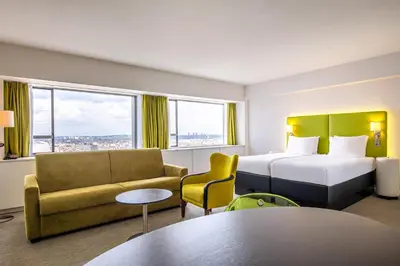 a hotel room with a bed and a couch at Thon Hotel Brussels City Centre in Brussels