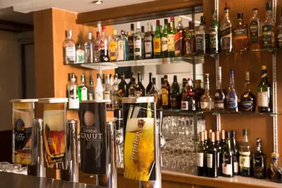 a bar filled with lots of bottles of alcohol at Holiday Inn Gent Expo by IHG in Ghent