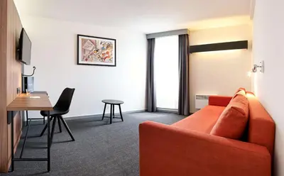 a living room with a couch and a table at Best Western Hotel Wavre in Wavre