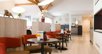 a restaurant with tables and chairs in a room at Best Western Hotel Wavre in Wavre