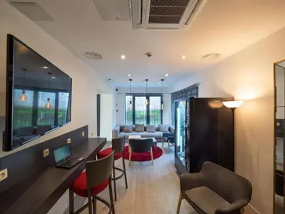 a living room with a table and chairs and a couch at Hotel Best Western City Centre in Brussels