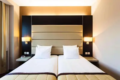 a hotel room with two beds and two lamps at Hotel Best Western City Centre in Brussels