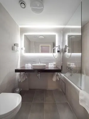 a bathroom with a sink and a toilet and a mirror at Hotel Best Western City Centre in Brussels
