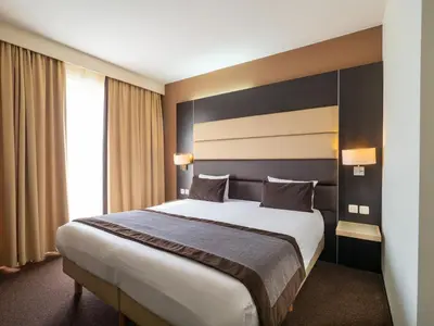 a hotel room with a large bed and a window at Hotel Best Western City Centre in Brussels