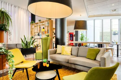 a living room with a couch and chairs at Holiday Inn Express Mechelen City Centre by IHG in Mechelen