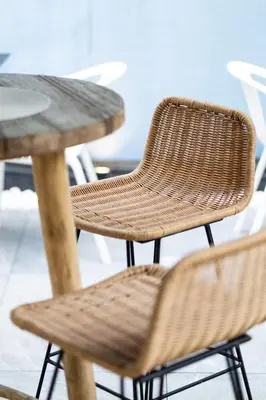 a wicker chair sitting next to a wooden table at Holiday Inn Express Mechelen City Centre by IHG in Mechelen
