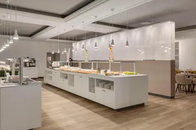 a kitchen with a counter with food on it at NH Collection Gent in Ghent
