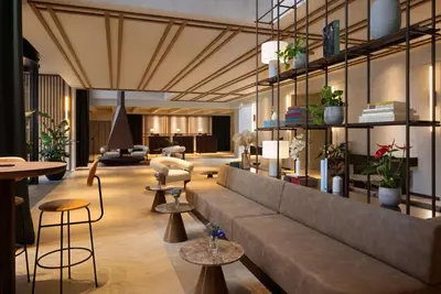 a lobby with a couch and some chairs and tables at NH Collection Gent in Ghent