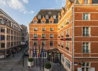 a tall brick building next to a street at Hotel Amigo, a Rocco Forte Hotel in Brussels