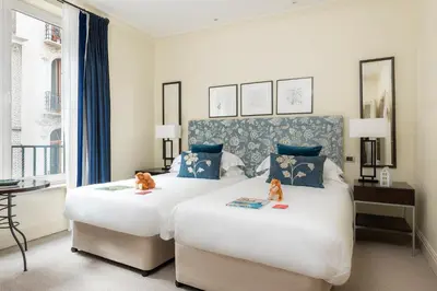 two beds in a hotel room with two cats on them at Hotel Amigo, a Rocco Forte Hotel in Brussels