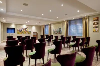a conference room with chairs and a tv at Hotel Amigo, a Rocco Forte Hotel in Brussels