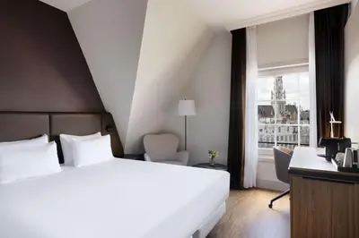 a hotel room with a bed and a window at NH Brussels Carrefour de L’Europe in Brussels